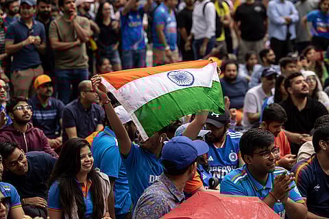 A fan with Indian flag at viewing party